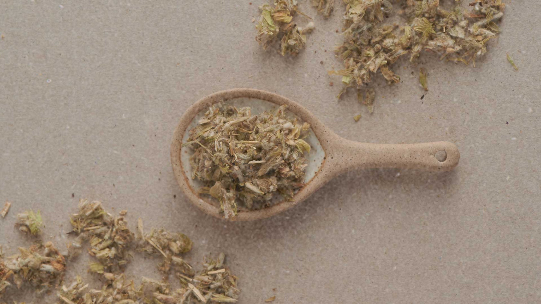 tea on ceramic tablespoon on beige surface f zeen boutique