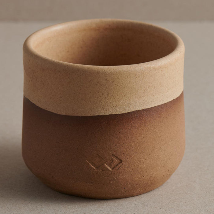 handmade ceramic cup in beige and brown colour on surface f zeen boutique